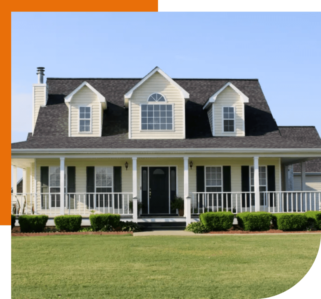 Modern dark gray tiled roof with two chimneys and a skylight window.